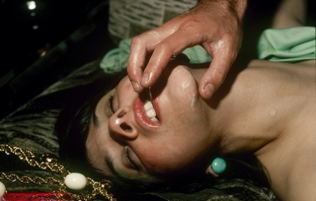 During an interracial pornographic film, attractive retro models are seen performing rounds of ejaculation.
