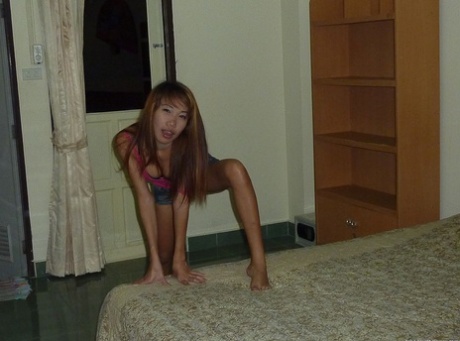 A Thai bar girl engages in sexual activity by giving a cock before sexual intercourse with a tourist.