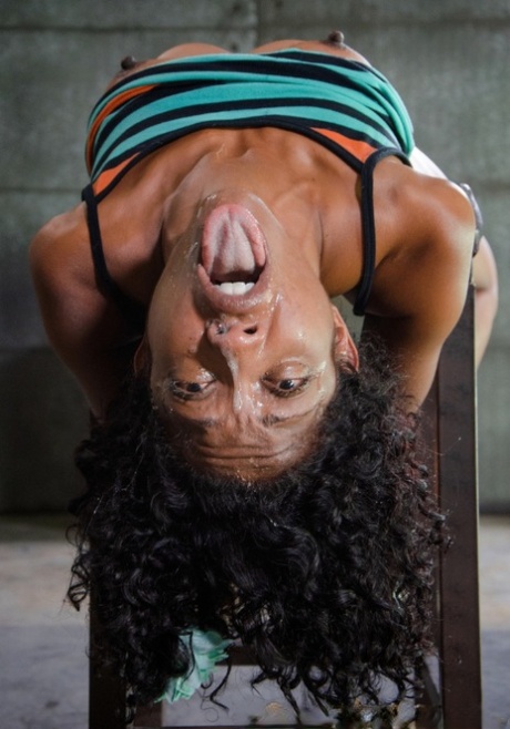 Lotus Lain, the ebony girl, was blindfolded and then tied to a chair for forced deep-throat and facial transformations.