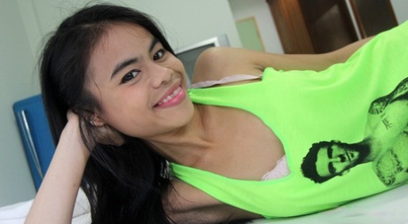 A tiny Thai college student teases about her bald coochies and small breasts.