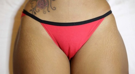 The hot Thai woman in shorts exhibits her hairy genitalia, which she displays by wearing a panty of cameltoe.