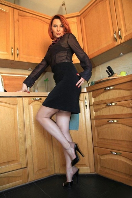 Redhead MILF Vixen Nylons Struts Around Her Kitchen In Hose And Garters