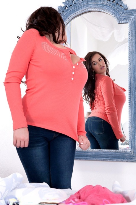 The curvy Leanne Crow gazes at herself in a mirror and then releases her knockers.
