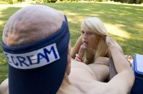 A young woman with blonde hair seduces and fucks an elderly man who is selling ice cream.