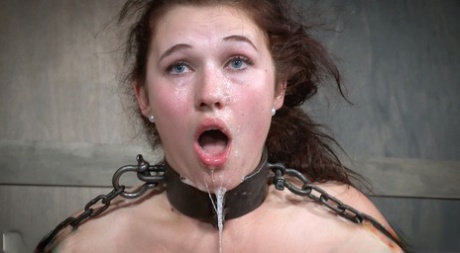 Stephie Staar, a submissive girl, experiences spitting and rubbing her chin in a dungeon.