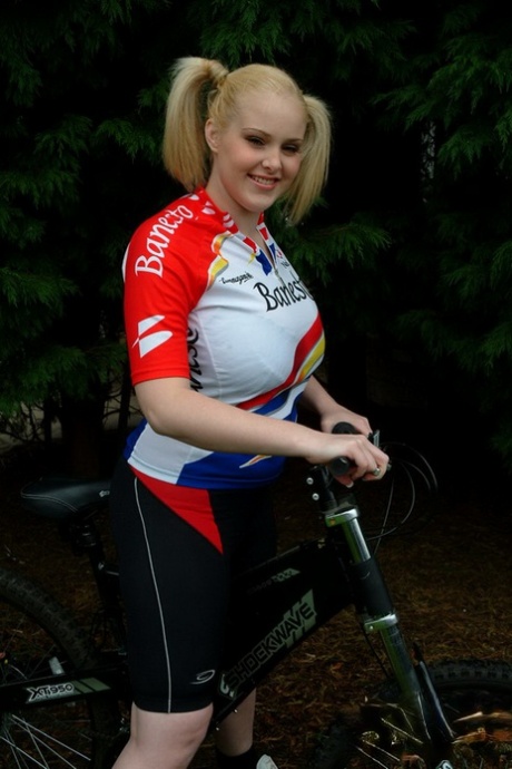 Blonde BBW Ashley Sage Ellison shows off her huge breasts in pigtails after cycling.