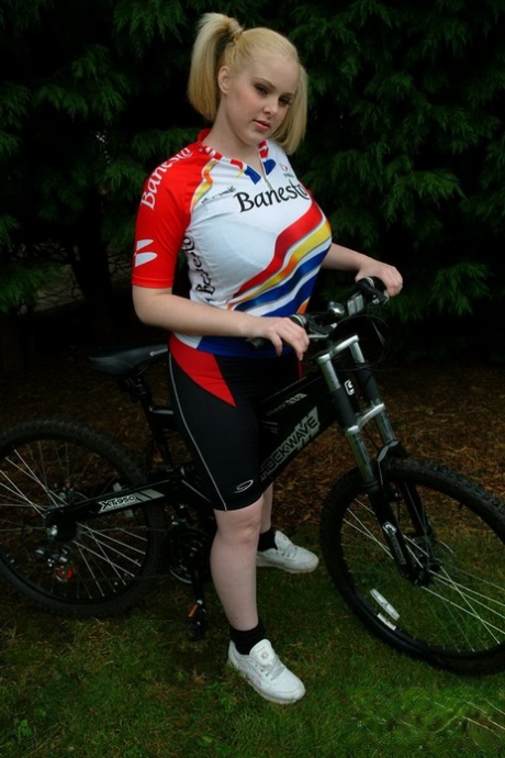 After biking, blonde BBW Ashley Sage Ellison displays her massive pigtails.