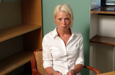Blonde Girl In A Black Skirt And White Blouse Is Placed In Handcuffs