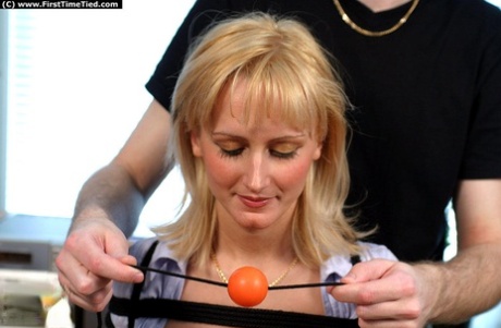 A blonde amateur who is busy with work performs a ball gag for the first time.