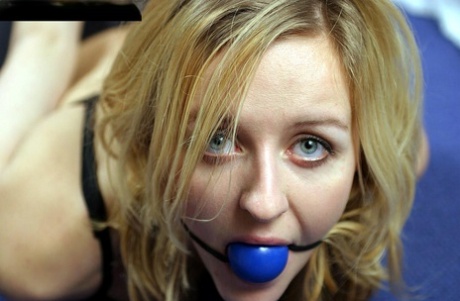 Blonde chick in black underwear and rope bindings spits out ball gag