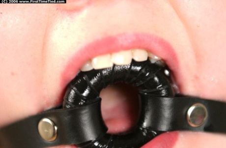 While practicing rope bondage, a novice fighter struggles to control his movements while drooling through O-ring gags.
