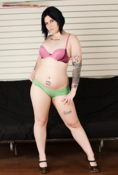 Tattooed plumper Green Eyed removes her lingerie and Mary Janes to pose nude