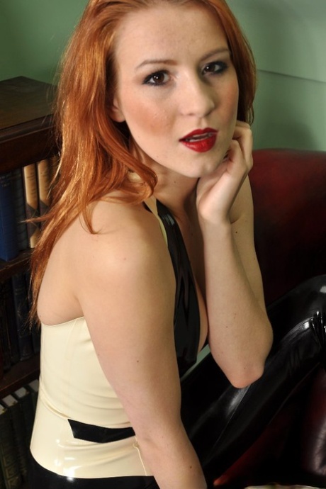 Natural Redhead Poses For A Safe For Work Sheet In Latex Clothing