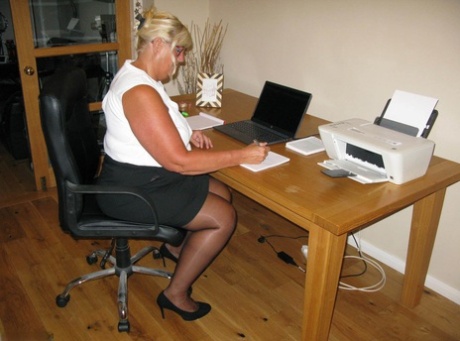 While working from her home office, blonde fatty Chrissy Uk exposes herself.