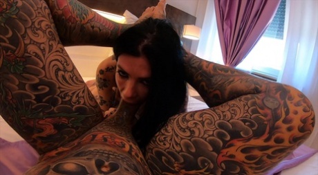 Megan Inky, the tattooed giraffe, displays a creampie after engaging in close sex with an inked man.
