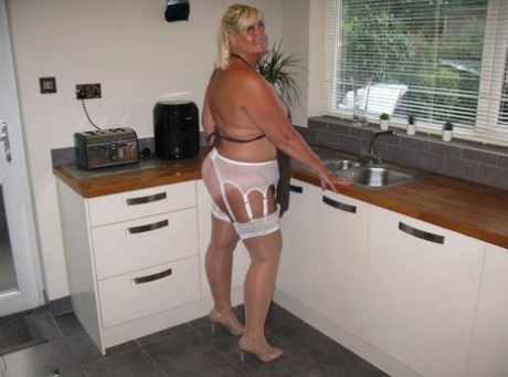 A battered, middle-aged blonde blond named Chrissy Uk covers her mostly nude body.
