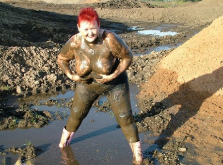 Valgasmic Exposed, a young redhead, dips into her thick body in mud at one point.