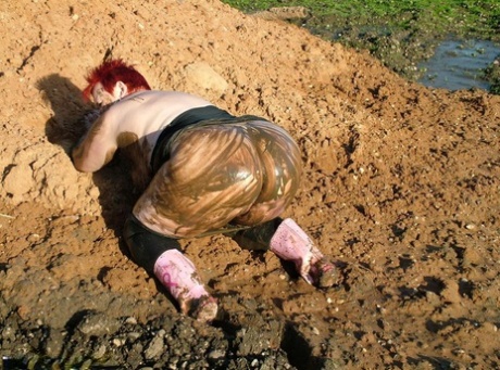 Despite being an adult, the overweight woman who goes by the name Valgasmic Exposed covers herself in some sort of mud.