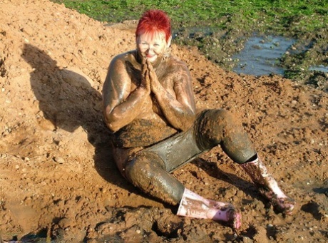 Exposed, a young redhead, covers her body with heavy bangs of saltwater.