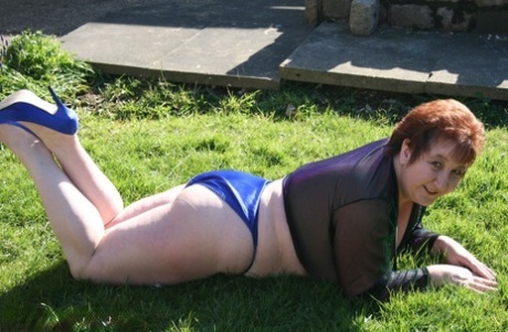 For a mature redhead like me, BBW Kinky Carol is the ultimate dream come true as she lets out her massive breasts in the yard.