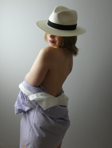 While wearing a hat, the amateur 'Posh' who is blonde exhibit her large breasts.