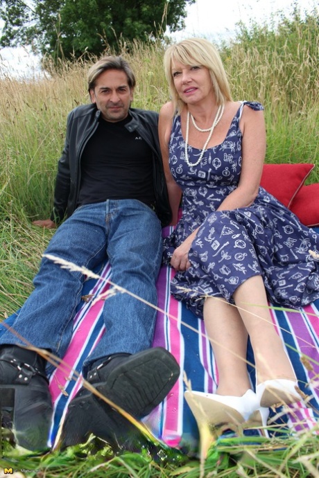 The older generation in the UK is hit on a doggystyle by a blanket lying beside a hay field.