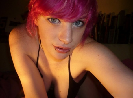 During solo action, the amateur girl with pink hair loosens her nice tits.