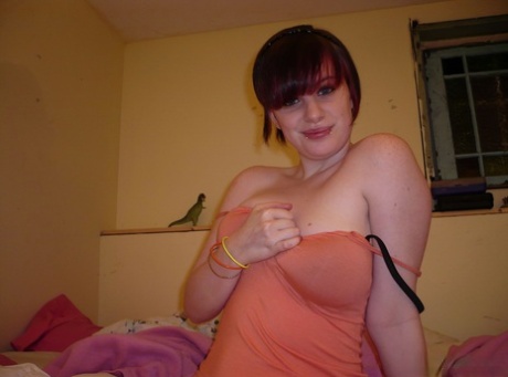 Redheaded amateur teases on her bed while wearing striped underwear