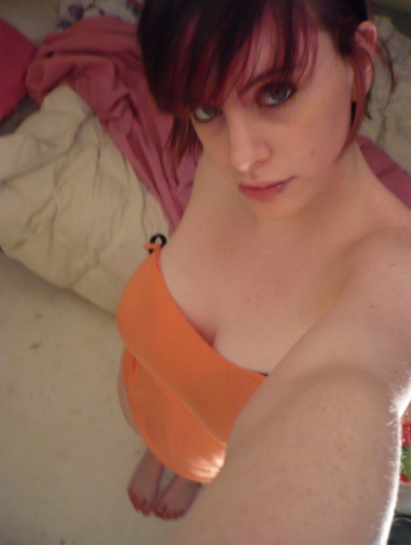 Wearing striped underwear, the redheaded amateur teases on her bed.