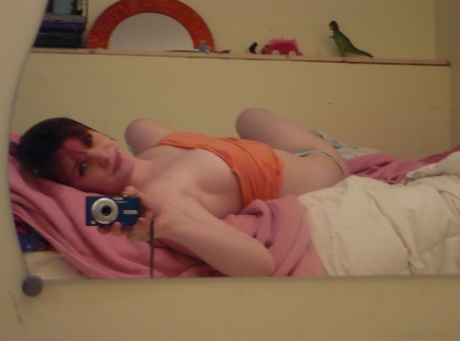 Redheaded amateur teases on her bed while wearing striped underwear