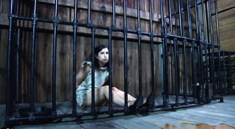 Marina, a white female prisoner, had a sexual encounter where she suckered a cock while being held in a dungeon.