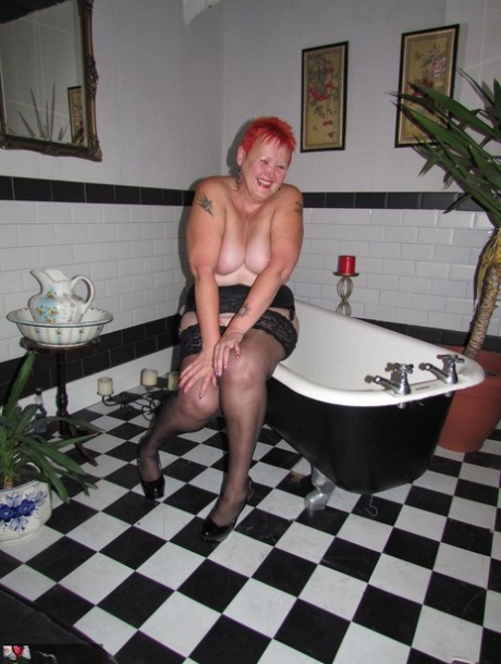 Older Redhead Valgasmic Exposed Steps Into A Bathtub While Wearing Stockings