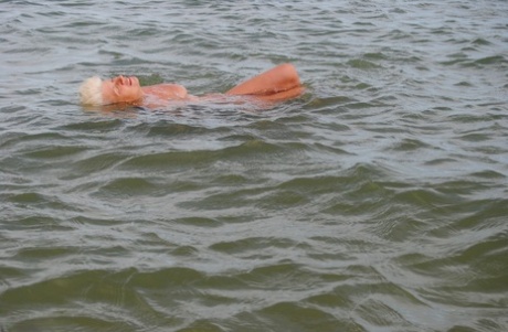 An elderly diver named Dimonty shows affection by giving a kiss after a night of swimming in the ocean.