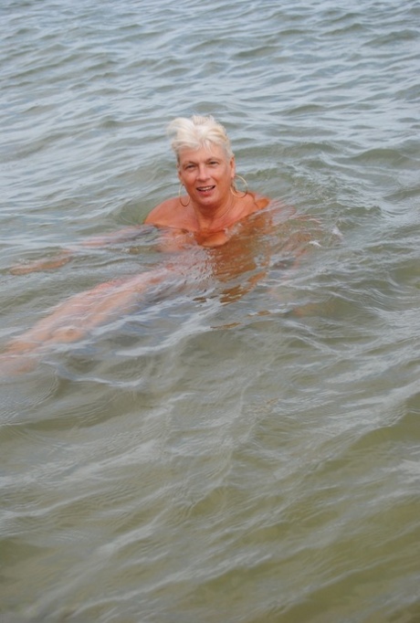 After swimming in the sea with a friend on the beach, Dimonty, an elderly man, gives her best wishes by blowing kisses.