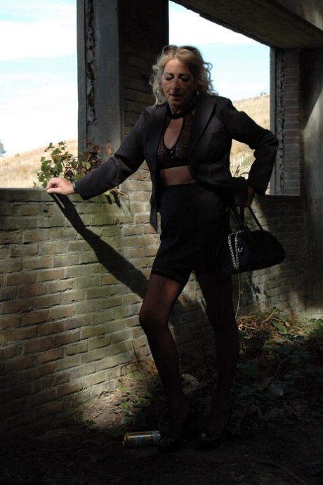 In her 20s, Kyras Nylons showcases a black skirt and stiletto heels with hosiery.