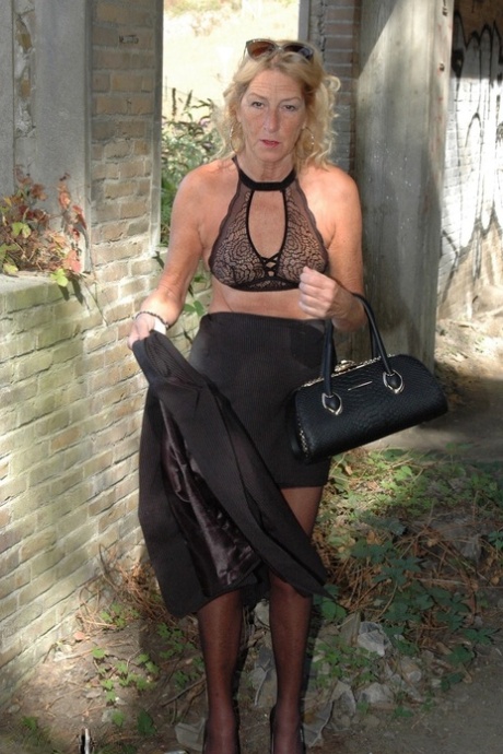 In hosiery with black skirt, Kyras Nylons models her perfectly good looking blonde figure wearing stiletto heels.