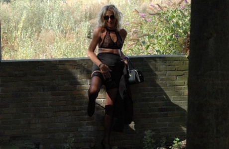 Aged 27-years-old Kyras Nylons wears hosiery and accessorized black skirt with stiletto heels.