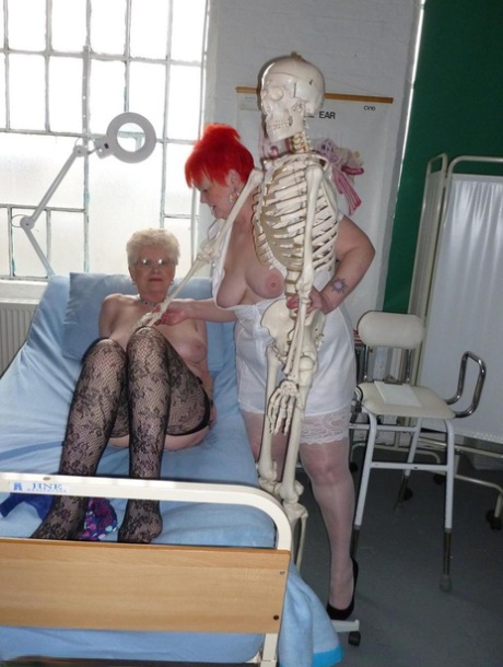 A skeleton is being played with by Valgasmic Exposed, a redheaded nurse, and an older woman who is quite large.
