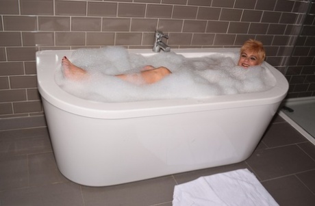 Mature Woman Dimonty Sports Short Hair While Taking A Bubble Bath