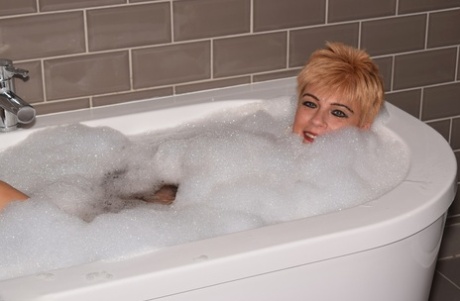 Mature Woman Dimonty Sports Short Hair While Taking A Bubble Bath