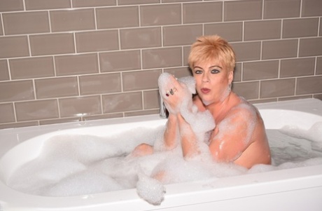 Mature Woman Dimonty Sports Short Hair While Taking A Bubble Bath