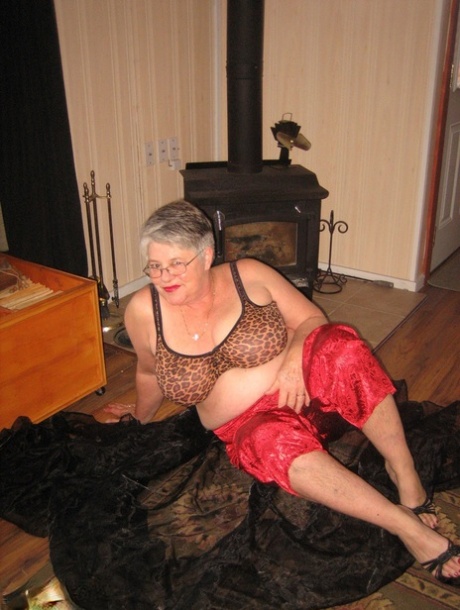 The Girdle Goddess, an old ladette who is not a professional, exposes herself in front of a parlour stove.