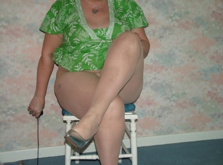 BBW Valgasmic, an older redhead who was quite old, had to wear pantyhose while sitting on a wooden chair.