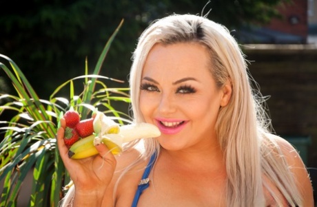 Big-tipped: BBW Jem Stone nibbles on a banana while eating on a patio wearing his mismatched heels.