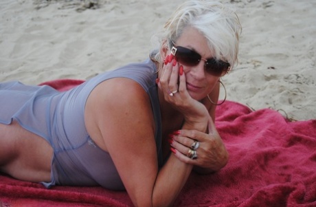 Amateur models of the blonde age Dimonty at the beach in bright colors wearing make-up and sunglasses.