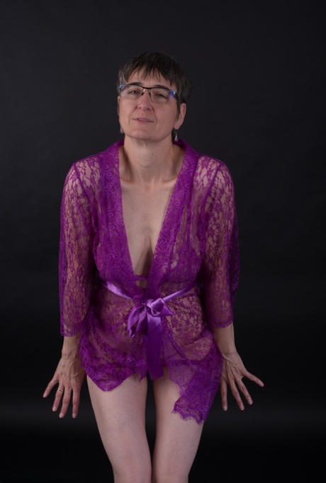 Older amateur sports short hair while modeling in purple lingerie