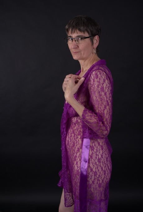 Older amateur sports short hair while modeling in purple lingerie