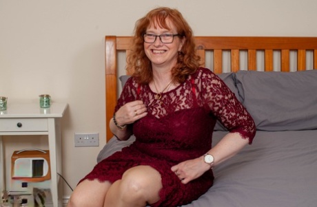 Older redheaded plumper toys are paired with her twat, which she wears a pair of tan stockings and glasses.