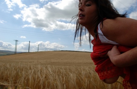 Nude: UK woman Juicey Janee eats strawberries while naked in a crop field.