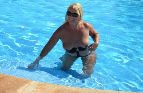 At the age of mid-six, Sweet Susi releases her breasts from a pool swimsuit and walks around in it.